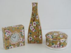 A Wedgwood 'May Flowers' square tapering spill vase and matching powder pot and cover together with