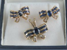 A delightful 9ct gold sapphire and diamond suite of jewellery comprising pendant and pair of