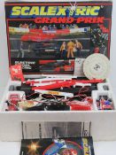 A Scalextric Grand Prix set in box having two race cars, track, penalty cars, barriers,