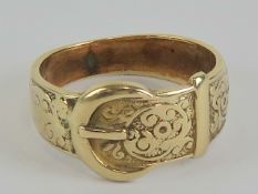 A 9ct gold ring in the form of a belt with buckle having engraved floral pattern to 'belt',