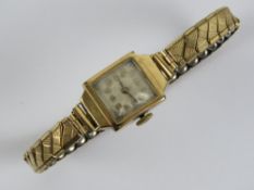 A vintage 9ct gold ladies cocktail watch on expanding rolled gold strap.
