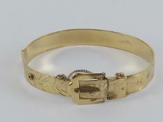 A finely made hinged bangle in the form of belt and buckle,