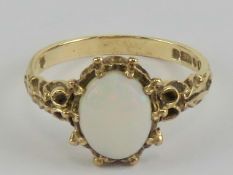 A 9ct gold multi-fire opal ring, cabachon measuring 8,6 x 6.