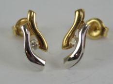 A pair of diamond 18ct white and yellow gold stud earrings, each hallmarked 750, 1.9g.