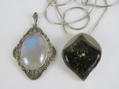 A silver and marcasite pendant with central lustre glaze cabachon, 5cm in length inc bale.