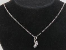A silver Links of London charm in the form of a shoe, on a sterling 925 silver chain,