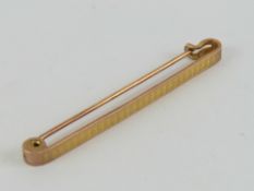 A 9ct rose gold bar brooch or stock pin having engraved pattern to front, 5cm in length, 2.5g.