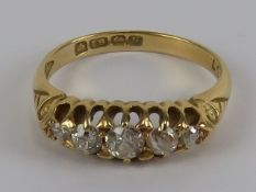 An 18ct gold and diamond 5 stone carved head ring, approx 0.