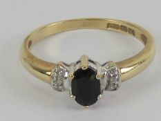 A 9ct gold sapphire and diamond ring, central oval cut sapphire approx 0.
