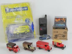 A vintage Motorola 'personal' flip front mobile phone together with four 'Days Gone' model cars,