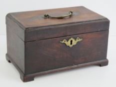 A Georgian mahogany square shaped tea caddy having brass hinged top handle and escutcheon plate,