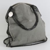A grey suede ladies handbag with chain detail, 38cm wide.