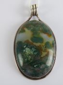 A large chalcedony and green agate pendant having white metal frame, no apparent hallmarks, 6.