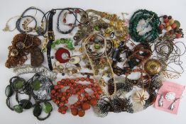 A quantity of assorted costume jewellery inc malachite bead necklace, bangles, shell bracelets,