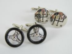 A pair of black enamelled cufflinks in the form of steering wheels,