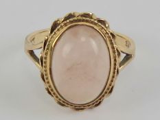A 9ct gold rose quartz ring, the central oval cabachon measuring approx 14 x 10mm, stamped 9ct,