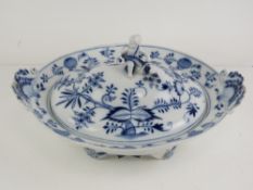 A Meissen footed oval tureen with shell handles and putti finial, blue onion pattern.