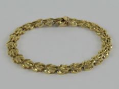 A 14ct gold articulated bracelet each panel in the form of a leaf, stamped 14k, 18.
