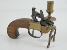 A candle holder in the form of an antiqu