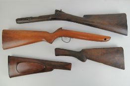 Four wooden rifle shoulder stocks.