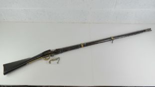An obsolete calibre British gun barrel and woodwork without block.
