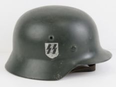 A reproduction WWII German SS M42 single decal helmet, having liner and chin strap,