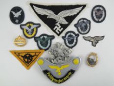 A quantity of reproduction WWII German items including; U-boat badge, E-boat 1st pattern badge,