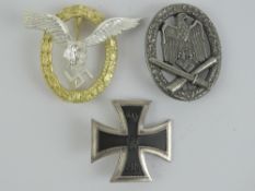 Three reproduction WWII German badges; Iron Cross 1st Class, Ground Assault, and Paratrooper.