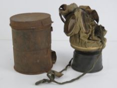 A WWI German gas mask with filter, in tin.