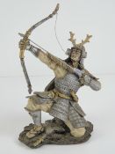 A contemporary figurine of a Japanese Samurai in armour with bow and arrow, a/f.