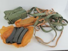 A quantity of PPS-43 slings, mag pouches and magazines.