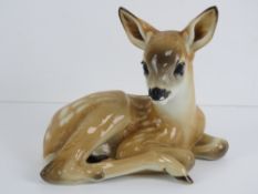 A rare SS Allach porcelain figure of a curled up fawn in light brown ground decorated with white