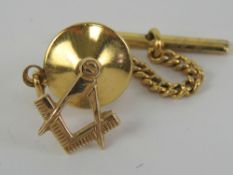 Masonic; a 9ct gold tie pin in the form of square and compass, 12mm high and stamped 9ct gold,