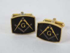 Masonic; A pair of Masonic cuff links having square and compass design upon.
