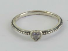 A silver Pandora ring having heart set w
