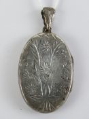 A HM silver locket having floral engravi