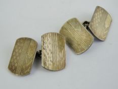 A pair of HM silver cufflinks having eng