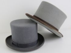 Two grey felt top hats; one hand made by