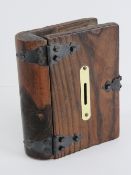 A wooden money box in the form of a book