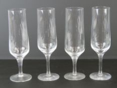 A set of four Orrefors Swedish Crystal champagne flutes each standing 19.5cm high.