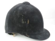 A velvet covered peak riding hat as made by Lock & Co London, size 7 1/4.