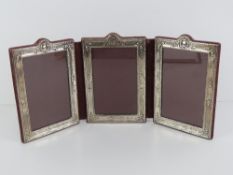 Asprey; A HM silver folding photograph frame to hold three photos, each measuring 14 x 9cm,