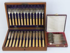 A set of twelve fish knives and forks all within a fitted wooden canteen.