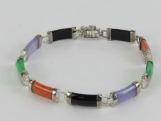 A jade and onyx panelled bracelet having white metal fittings (partial mark indistinct),