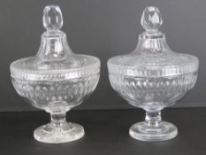A pair of heavy cut glass lidded bonbon dishes, each standing 20cm high.
