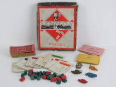 A vintage travel sized set of Monopoly having metal counters, manufactured by John Waddington Ltd,