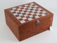A chequer top faux walnut lidded box having under-drawer containing a full set of wooden chess