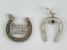 A silver 'Good Luck' horse shoe charm or pendant,