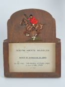 A 1930's easel hunting meet card stand having pierced and coloured mounted huntsman in full cry