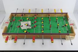 A 1970s Arcofalc Italian made table football game with full complement of players and two balls.
